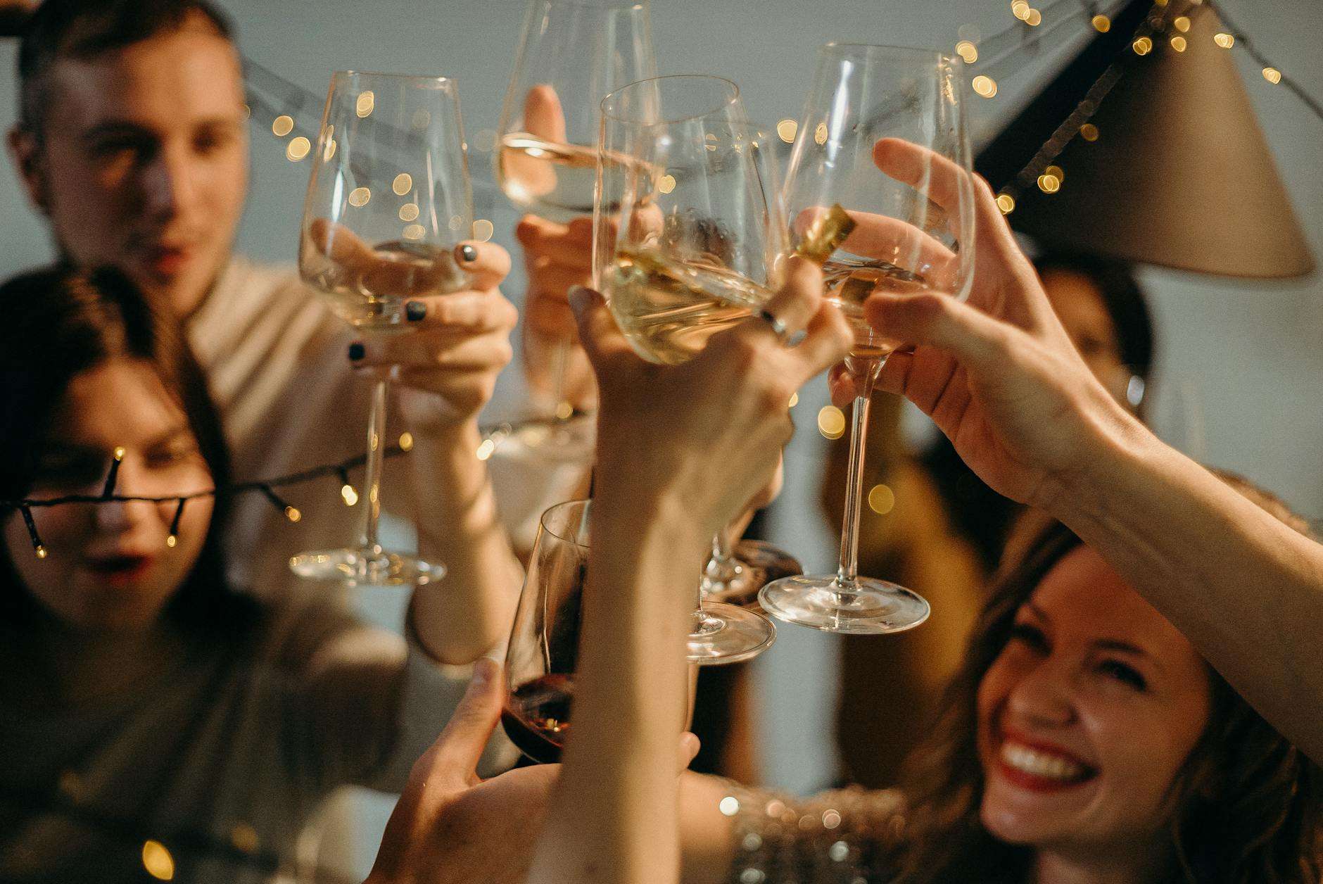 selective focus photography of several people cheering wine glasses